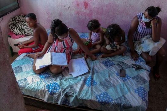 Studying a copy of a textbook in Pernambuco, Brazil